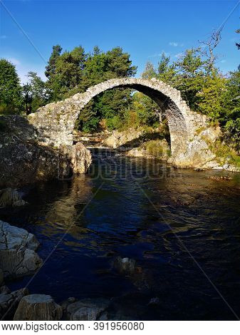 A View Of The Historic Pack Horse Bridge Over The River Dulnain In Carrbridge, Scotland