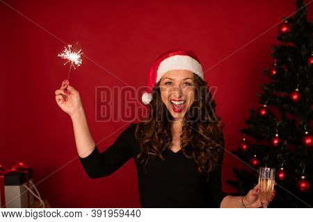 Cheerful Attractive Woman In Santa Hat Celebrating New Year, Christmas, Hanukkah, Kwanzaa Holiday. S
