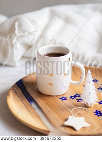Ceramic Mug With Stars With Black Coffee, White Christmas Tree And Ctramic Star On A Tray On A Light