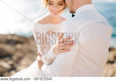 Bride And Groom Are Hugging On The Rocky Beach Of The Mamula Island
