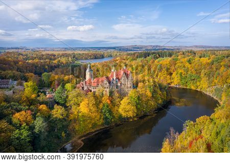 Aerial View Of Czocha Castle Surrounded By Autumn Forest And Lesnianskie Lake