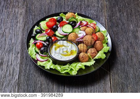 Mediterranean Platter Of Falafels, Tomatoes, Cucumber, Red Onion, Black Olives, On The Fresh Salad L
