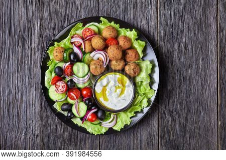 Mediterranean Platter Of Falafels, Tomatoes, Cucumber, Red Onion, Black Olives, On The Fresh Salad L