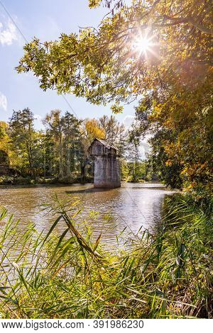 Wooden Cottage On Abandoned Bridge Pillar In Autumn Sunny Day