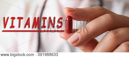 Cropped View Of Doctor In White Coat Holding Pill With Finger. Nearby Is The Inscription On The Medi