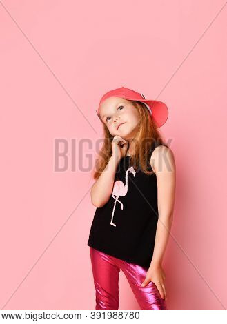 Thoughtful Preschool Girl Looking Up Propping Her Cheek With Hand While Trying To Make A Desicion. T