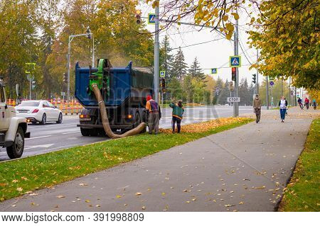 Moscow. Russia. October 11, 2020. Utility Workers Remove Yellow Autumn Leaves With An Industrial Vac