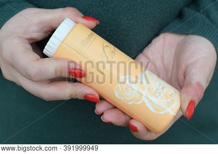 Young Girl Holds Oriflame Volare Fragranced Body Talc. Oriflame Holding Ag Is A Multi-level Marketin