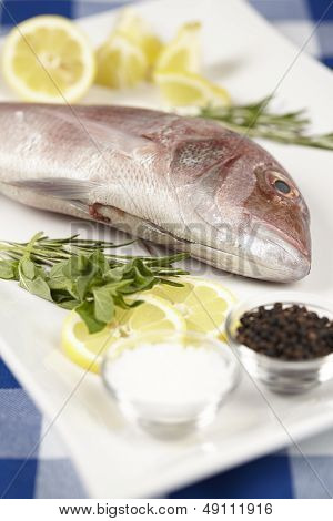 A Red Sea Bream With Spices, Lemon Slices And Herbals
