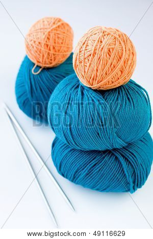 Five bright balls of yarn and two knitting needles