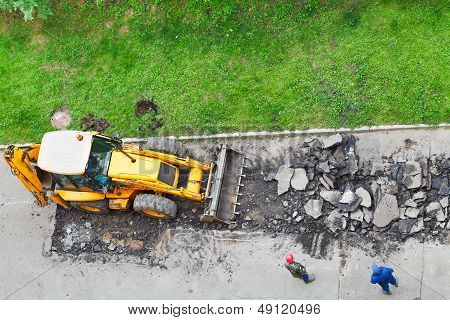 Tractor Removes Asphalt From Road