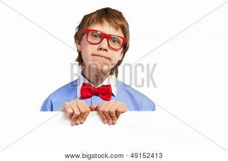 School boy in red glasses holding white square