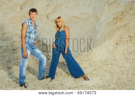 Guy And  Girl In  White Sand