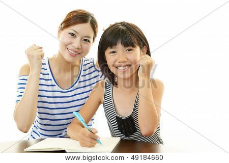 Girl studying with mother