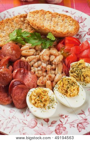 Deviled eggs with beans and sausage, rich and tasty breakfast plate
