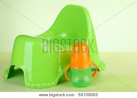 Green potty on color background