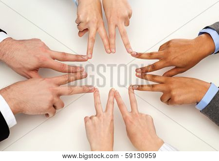 business and succcess concept - group of businesspeople showing v-sign