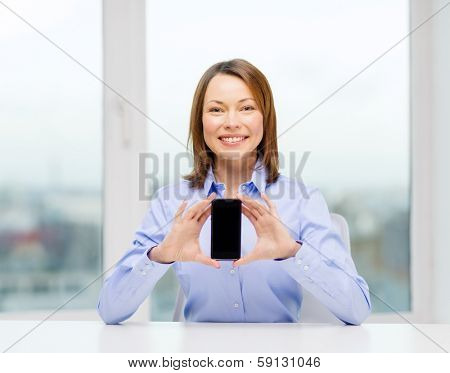 business, office, school and education concept - smiling businesswoman with black blank smartphone screen in office