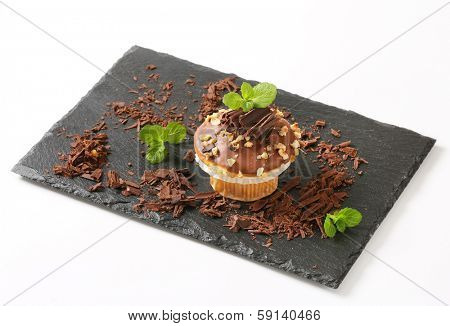 delicious home made muffing with chocolate,served on a slate board