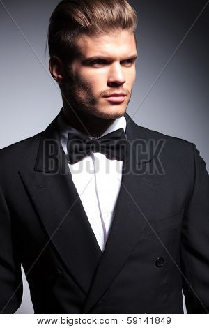 face of a handsome caucasian man in tuxedo posing in studio