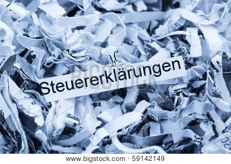 shredded paper tagged with tax returns, symbol photo for tax burden and retention requirements