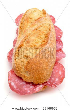 closeup of a spanish bocadillo de salchichon, a sandwich with spanish salami, on a white background