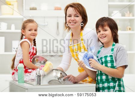 Kids helping their mother in the kitchen - washing the dishes together
