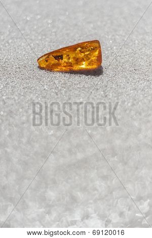 amber with inclusions on sand