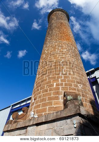 Ancient brick pipe in the old sugar cane factory. Mauritius.