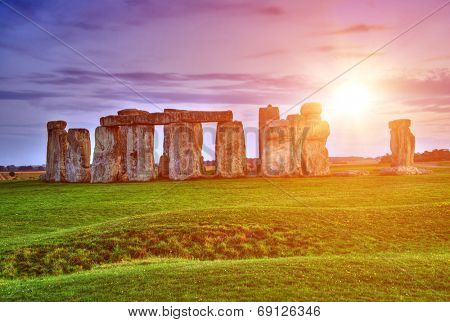 Fantasy sunrise at Stonehenge with dramatic sky and sun rays