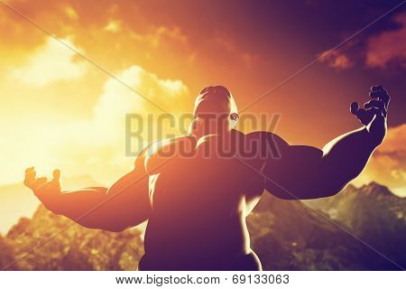 Very muscular strong man with hero, athletic body shape expressing his power and strength on the peak of the mountain at sunset