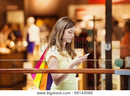 Shopping girl with smartphone