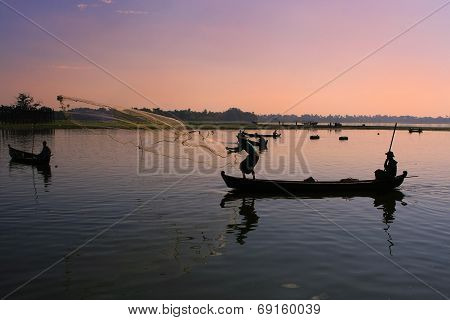 AMARAPURA, MYANMAR - DECEMBER 31: An unidentified man fishes in a lake on December 31, 2011 in Amara