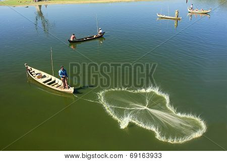 AMARAPURA, MYANMAR - DECEMBER 31: An unidentified man fishes in a lake on December 31, 2011 in Amara