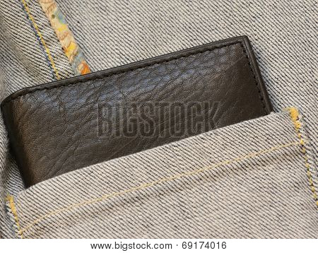 Leather purse out of denim jacket's close up