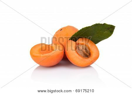 Three Sliced Apricots With Leaf Isolated On White