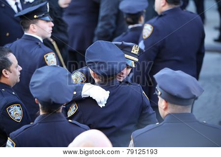 NYPD officers embrace outside church