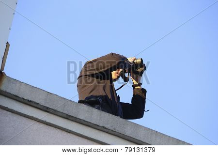 Rooftop security with binoculars