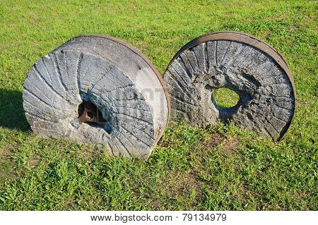 ancient millstone on the grass, natural background