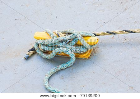 Blue Frayed Rope On Yellow Cleat