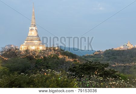 White Pagoda Illuminated On Hill At Sunset