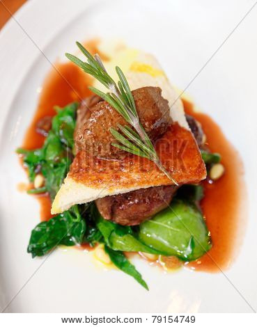 Tenderloin steak with beef terrine and spinach in plate