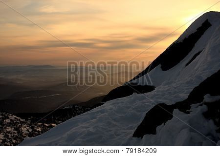 Sunset is in mountains.