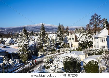 Snow Coverede Houses And Mountains In Schwalbach