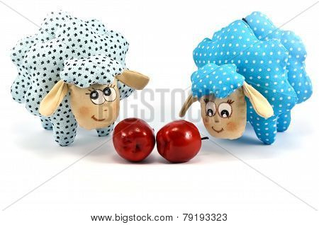 Two rag-dolls speckled lambs with apples
