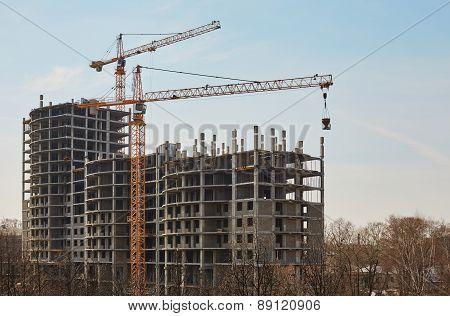 Image of building under construction and cranes