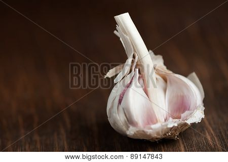 Garlic bulb resting on wood surface
