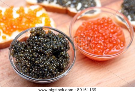 Black and red caviar in glass container