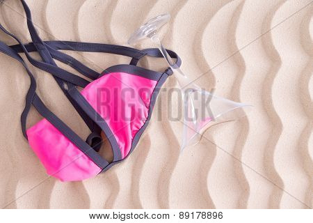 Fun Pink Bikini Top And Martini Glass On The Beach