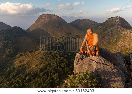 CHIANG DAO, THAILAND, JANUARY 05, 2015: A Buddhist monk master is meditating at the top of the Chiang Dao mount at dusk for the new year in Thailand.